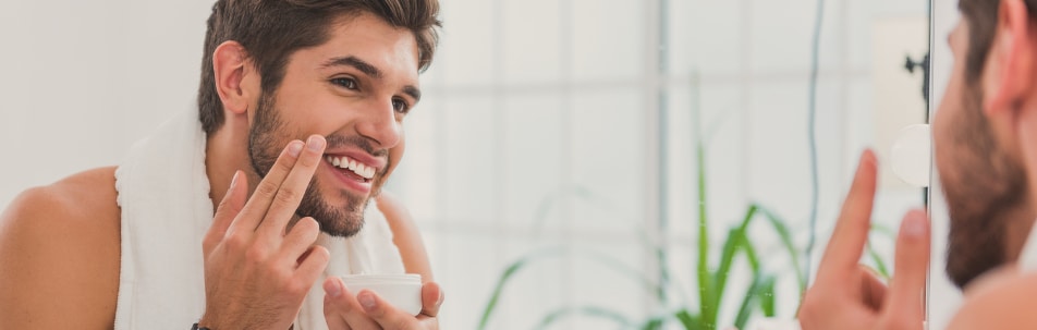 banner image of man rubbing topical cream into skin on his face